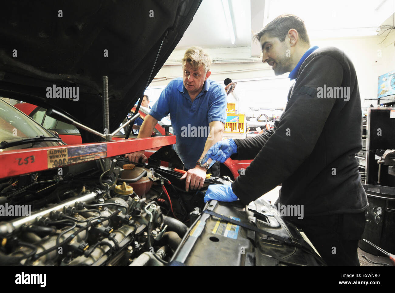 Mechanic checking car engine Stock Photo Alamy