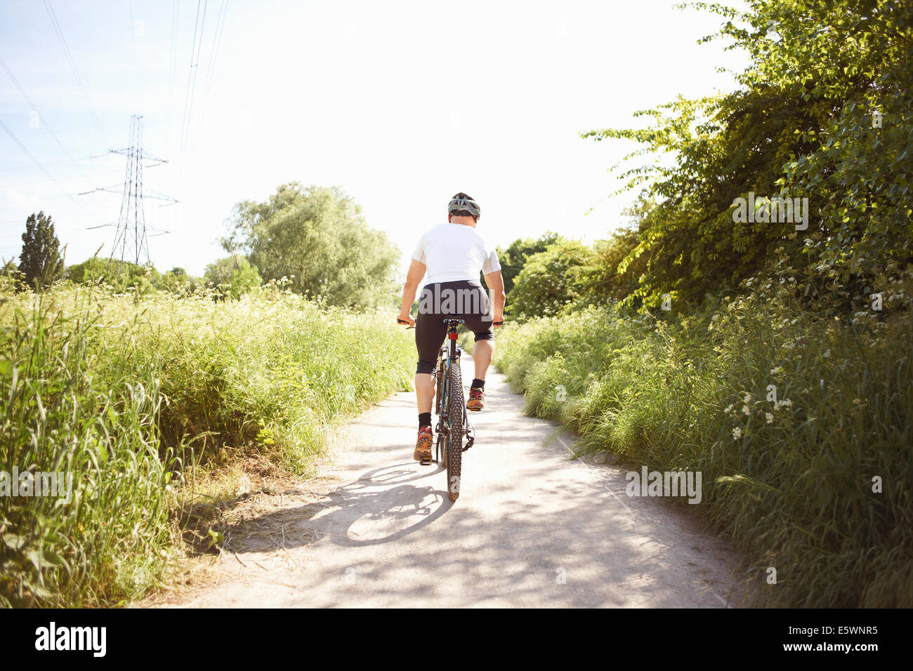 Cyclist cycling on path Stock Photo