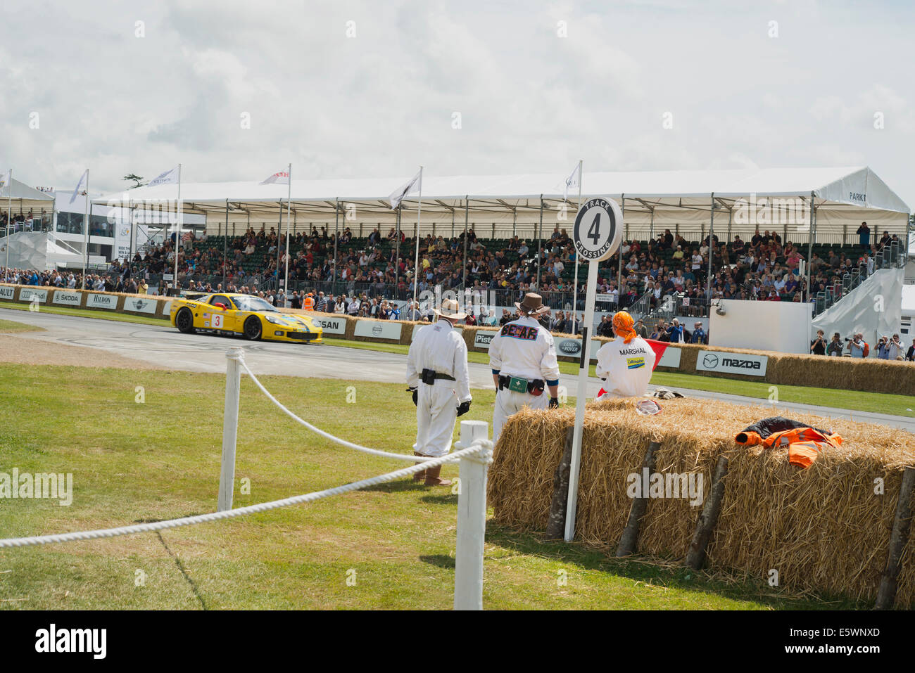 Hill climb track at Goodwood Festival of Speed. With marshalls watching a car return down the hill. Stock Photo
