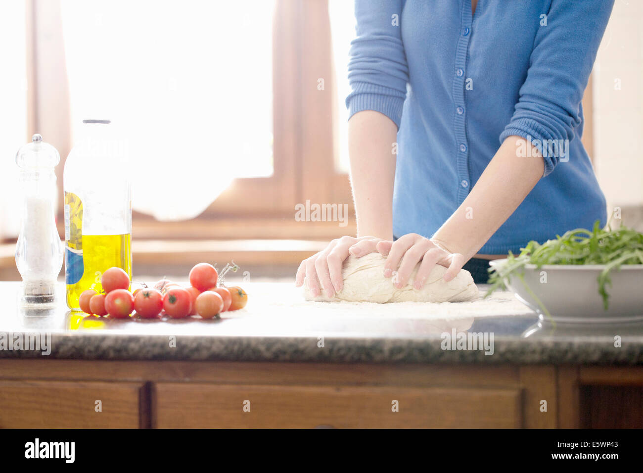 Cropped shot of young woman kneading pizza dough Stock Photo - Alamy