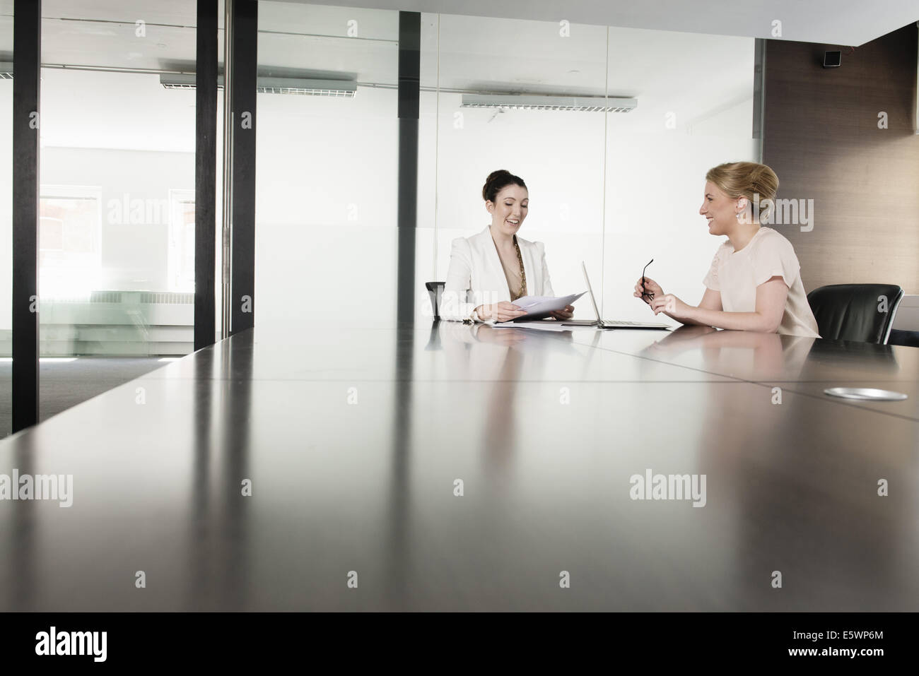 Two young businesswomen meeting in boardroom Stock Photo