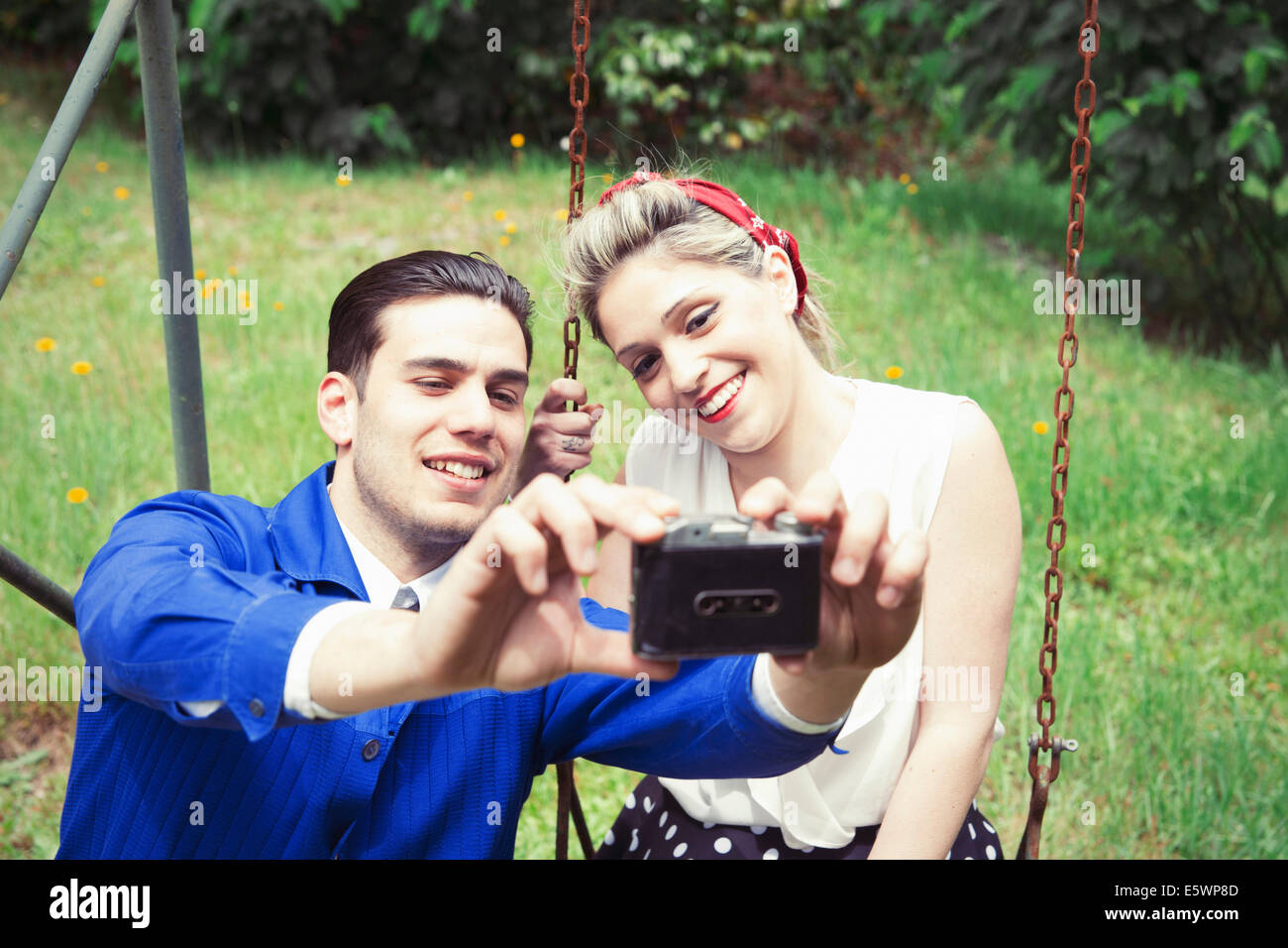 Young vintage couple taking selfie camera in garden Stock Photo