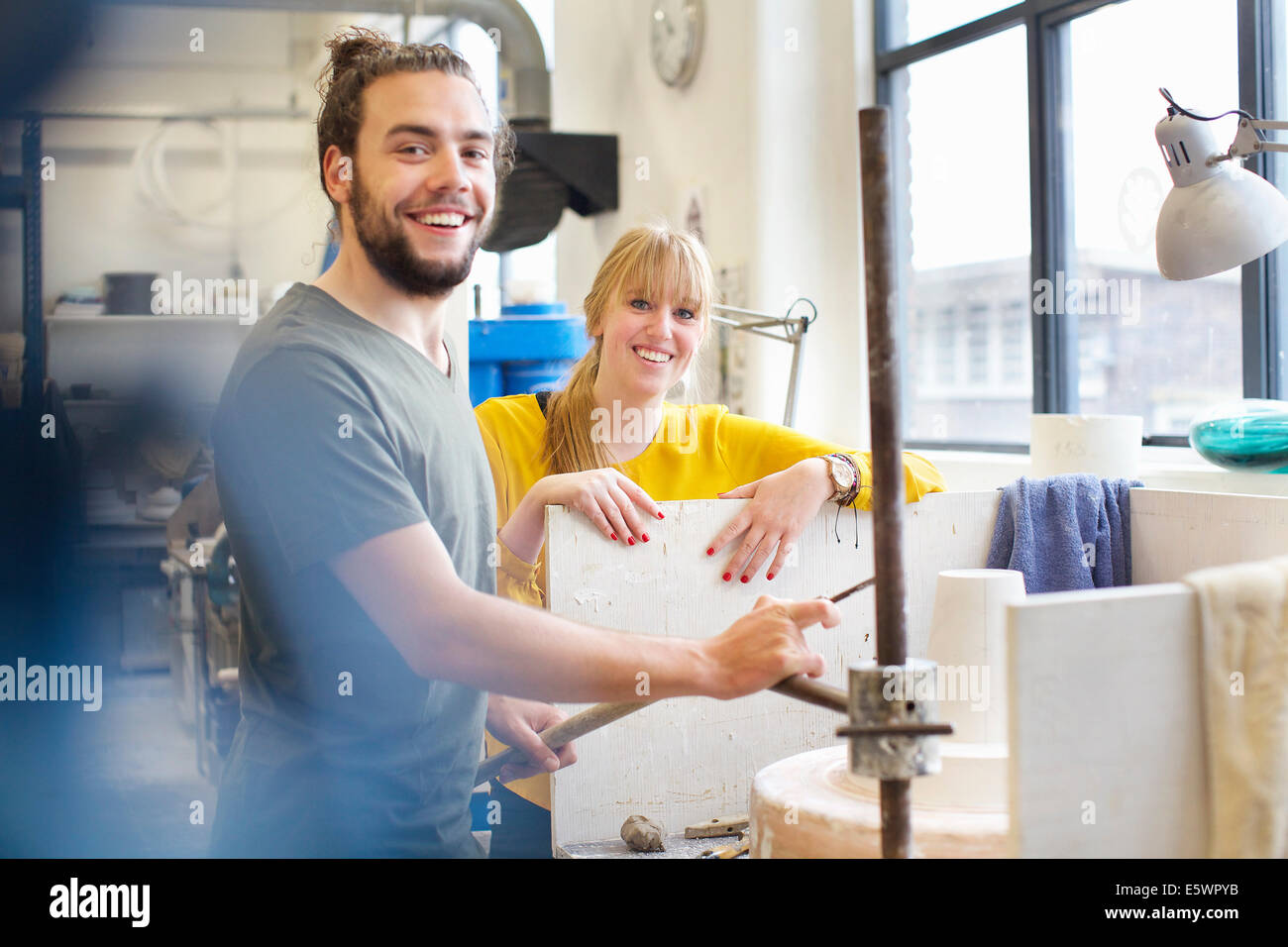 Potter couple working in ceramic workshop Stock Photo - Alamy