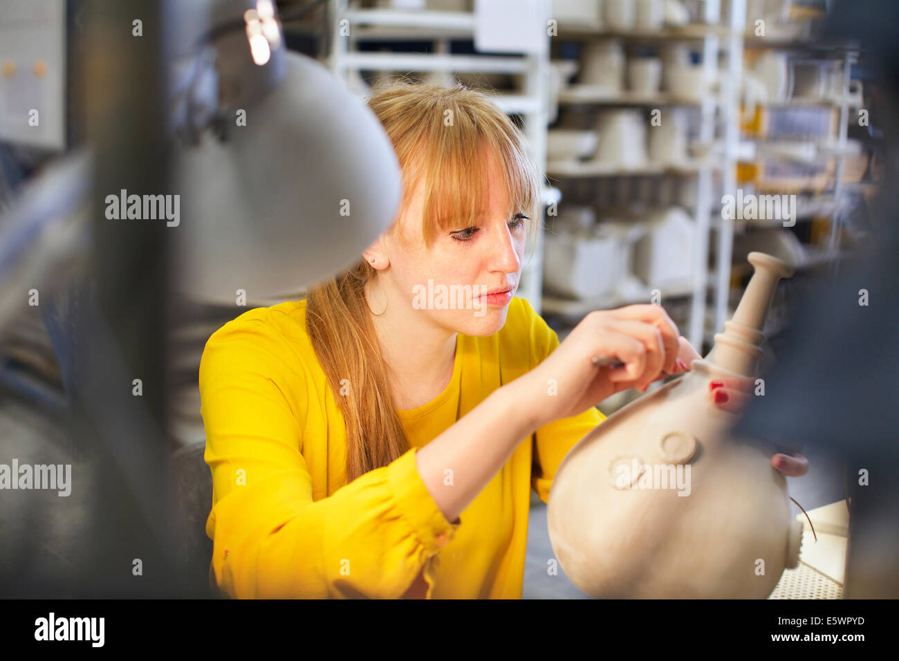 Female potter working in ceramic workshop Stock Photo - Alamy