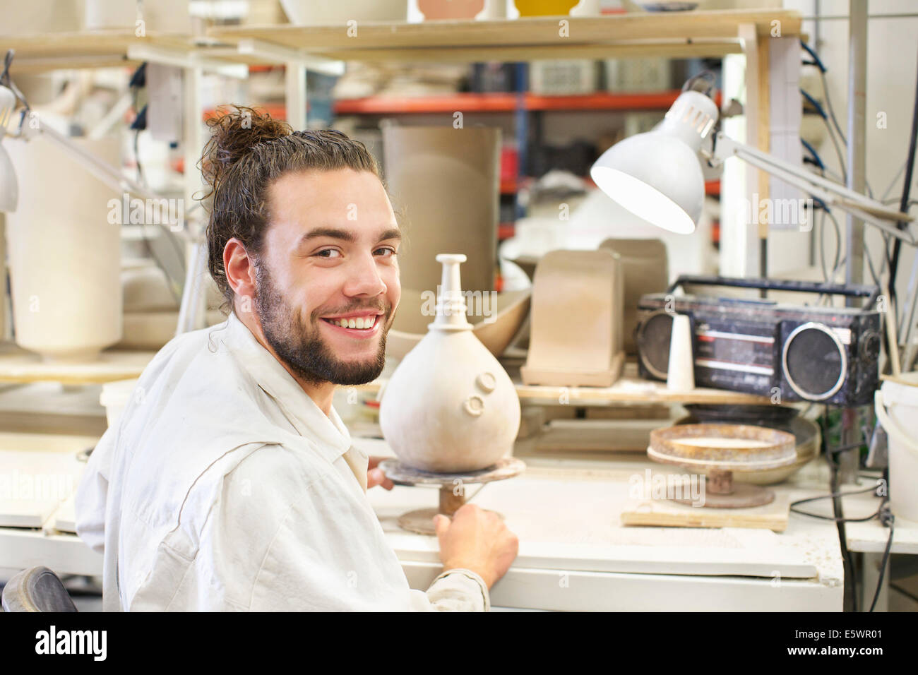 Male potter working on vase in ceramic workshop Stock Photo - Alamy