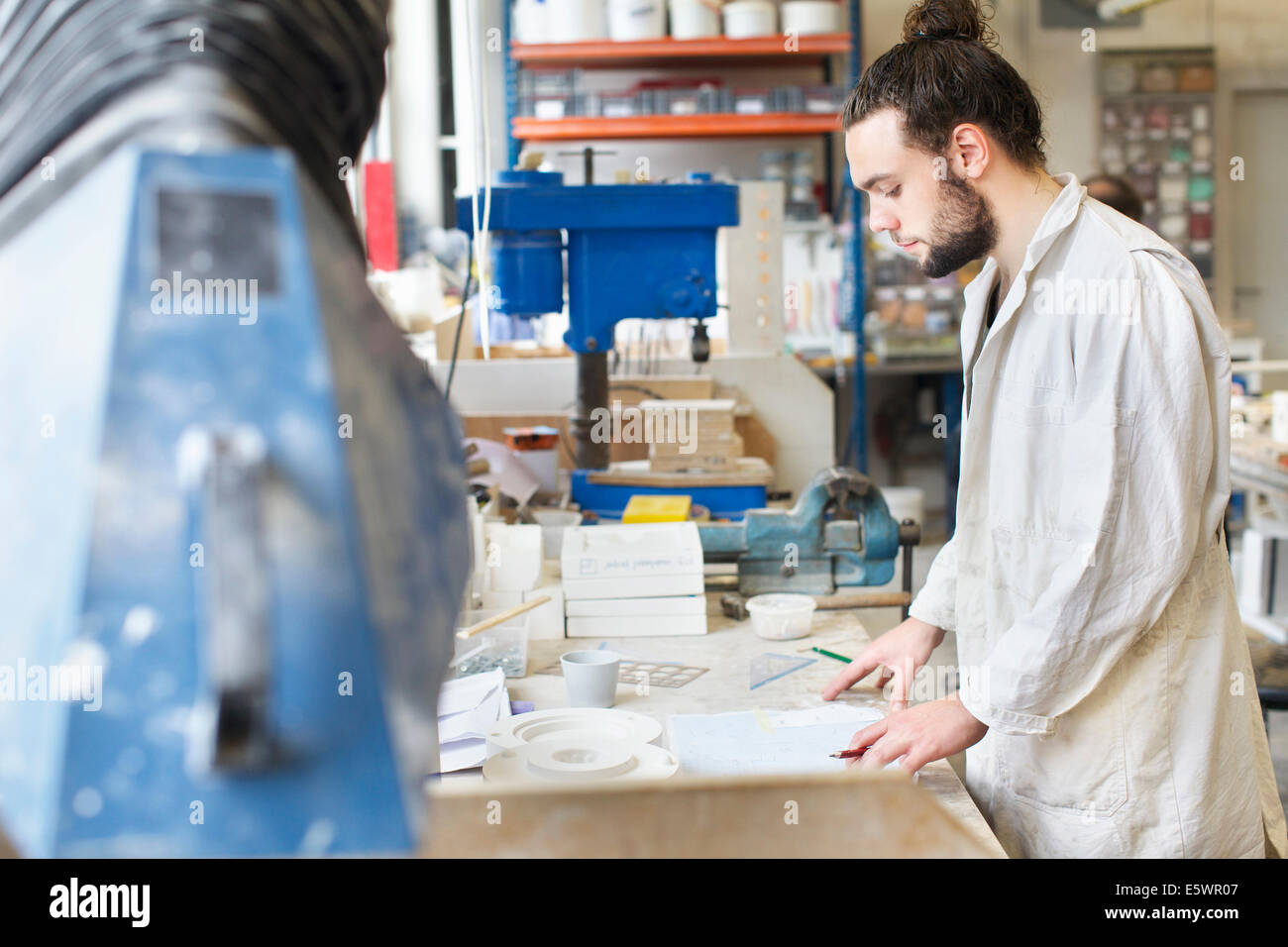 Male potter working in ceramic workshop Stock Photo - Alamy
