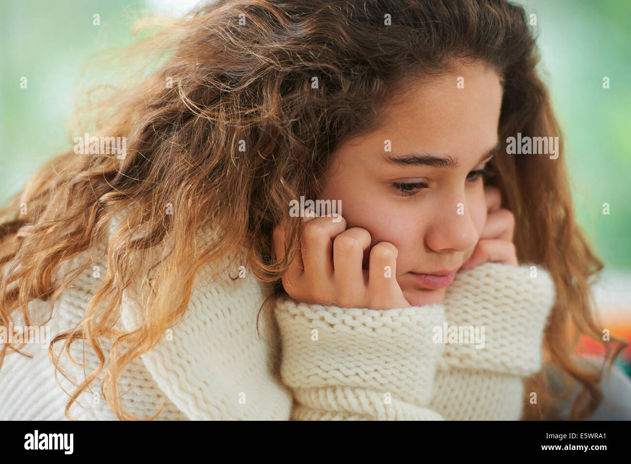 Young girl with brown hair, pensive expression Stock Photo