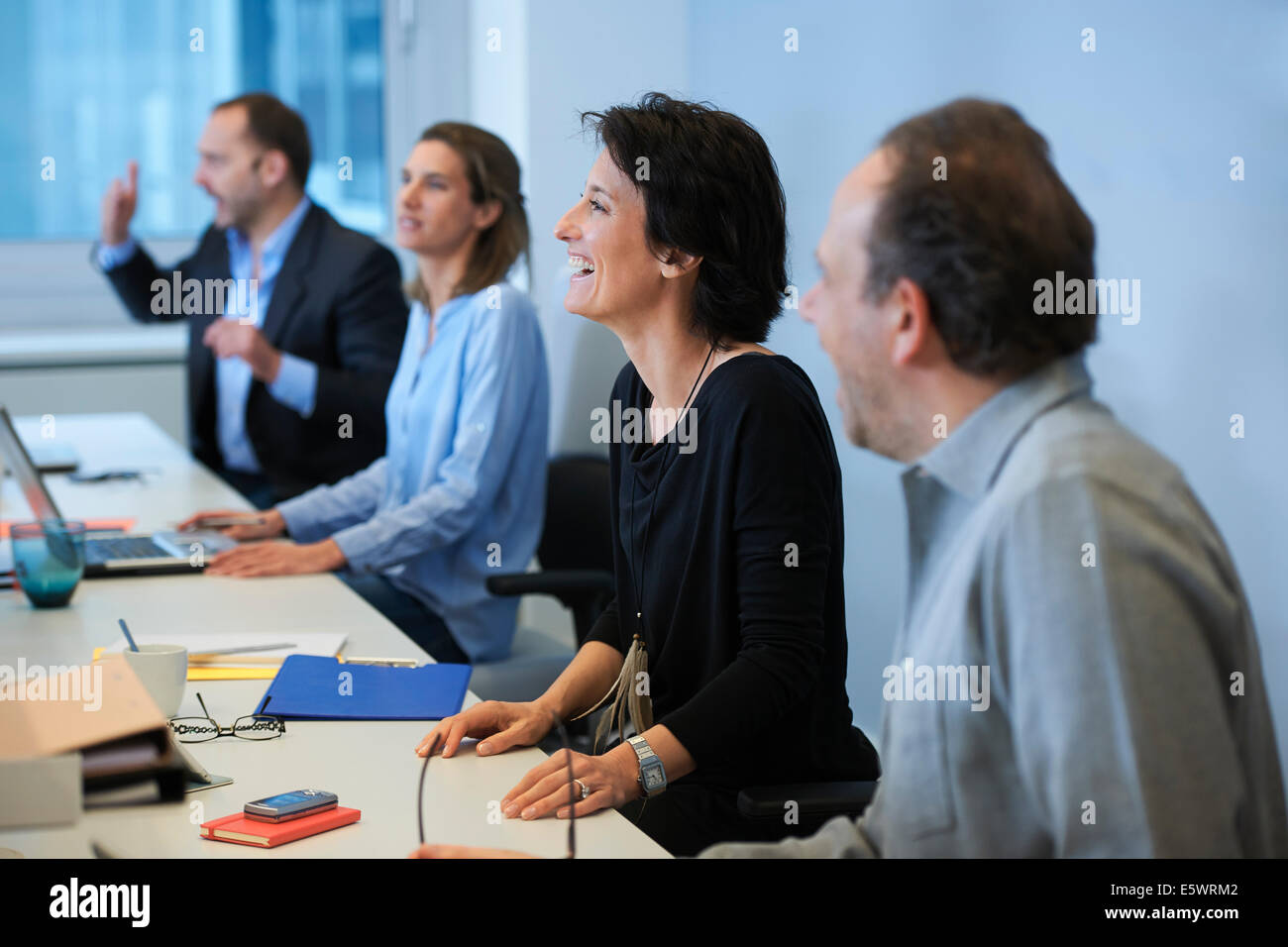 Businesspeople sitting at desk Stock Photo
