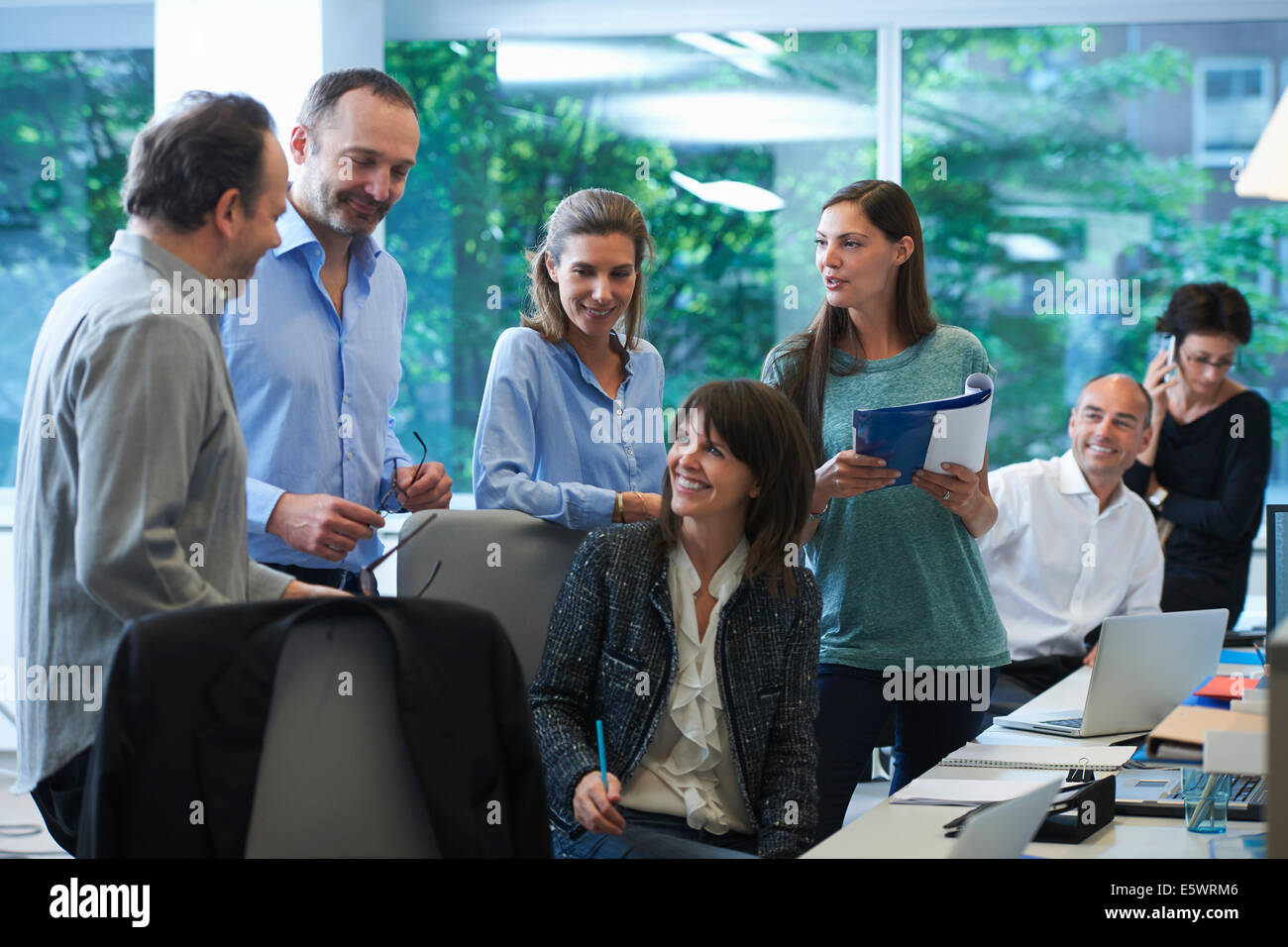 Businesspeople meeting around desk Stock Photo