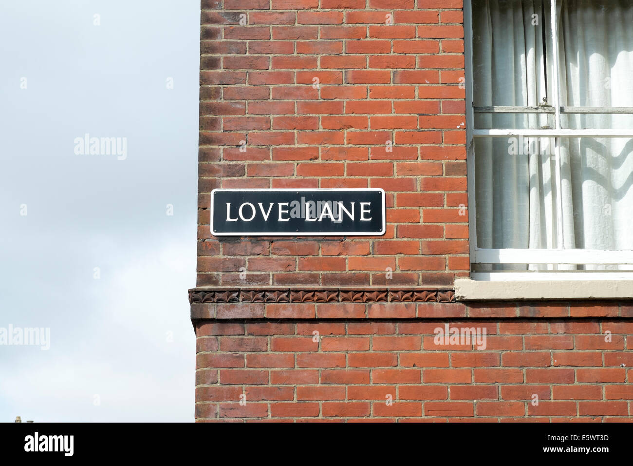 Love Lane street name sign on side of red brick building UK Stock Photo