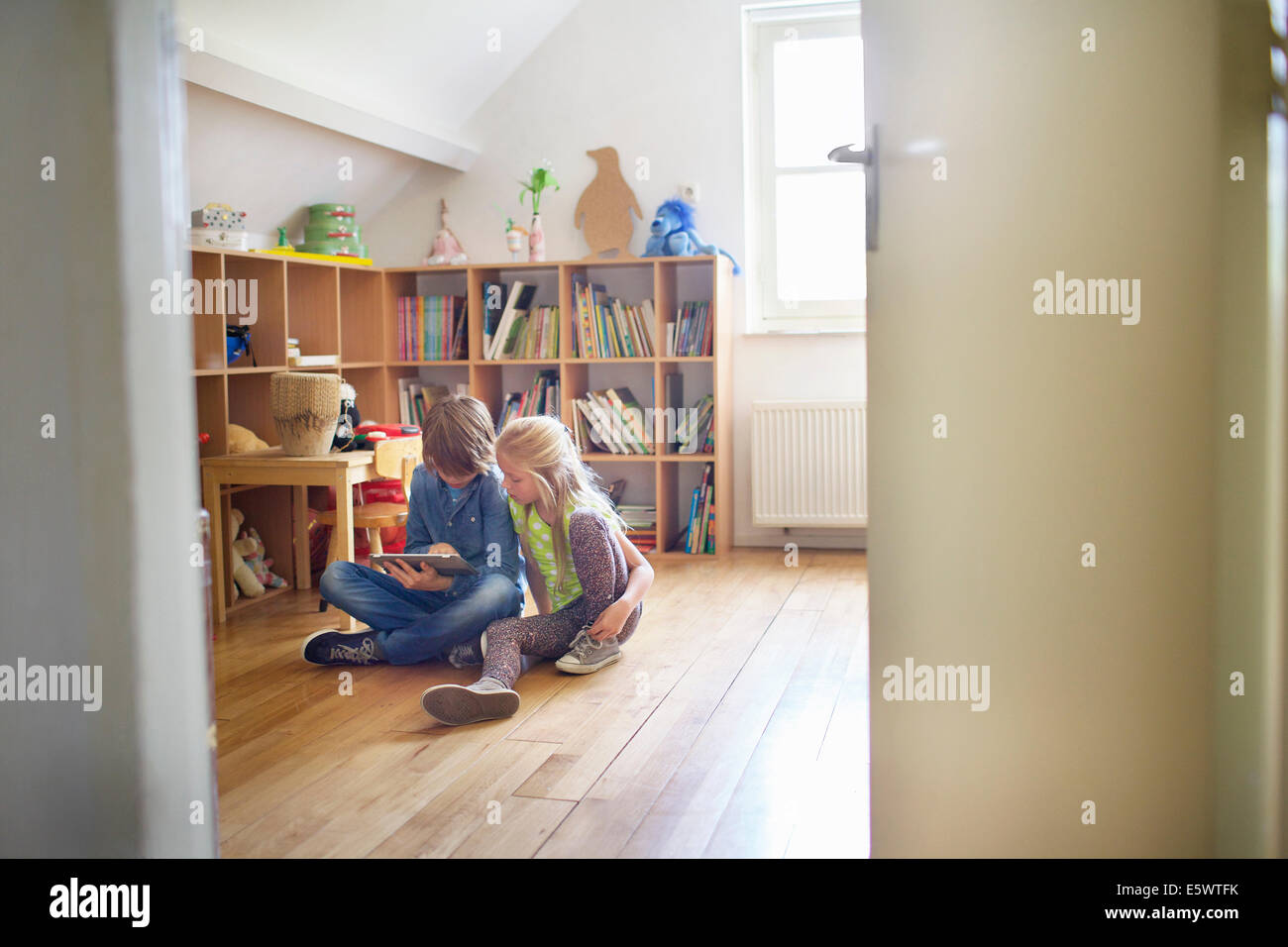 Brother and sister sharing and using digital tablet Stock Photo - Alamy