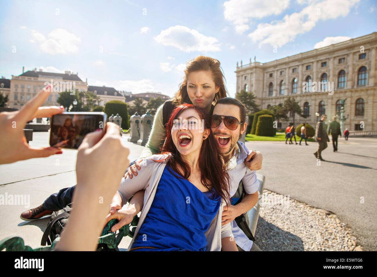 Young adult woman taking picture of friends Stock Photo