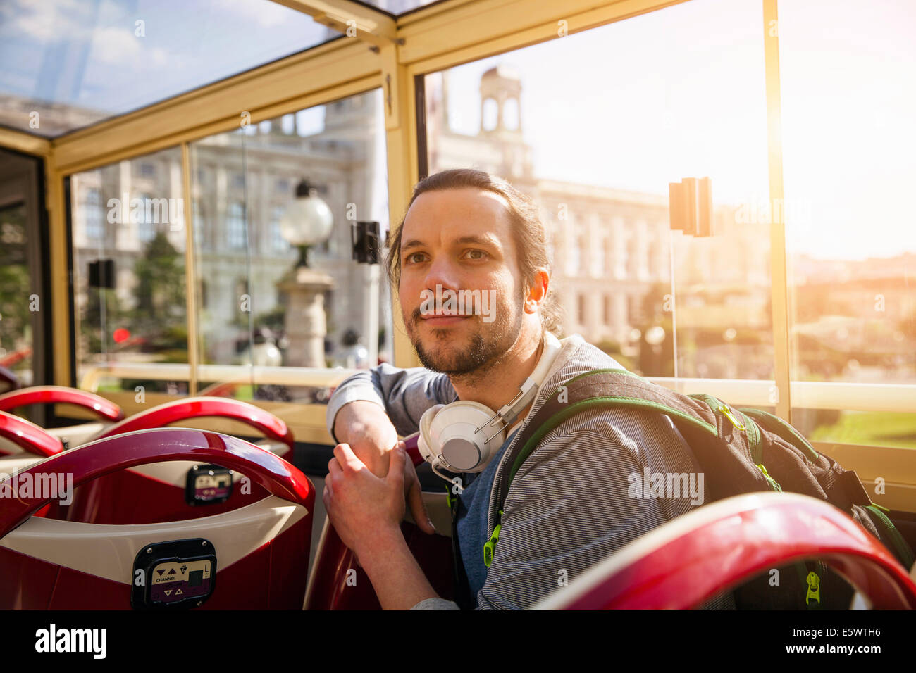 Young adult man on bus Stock Photo