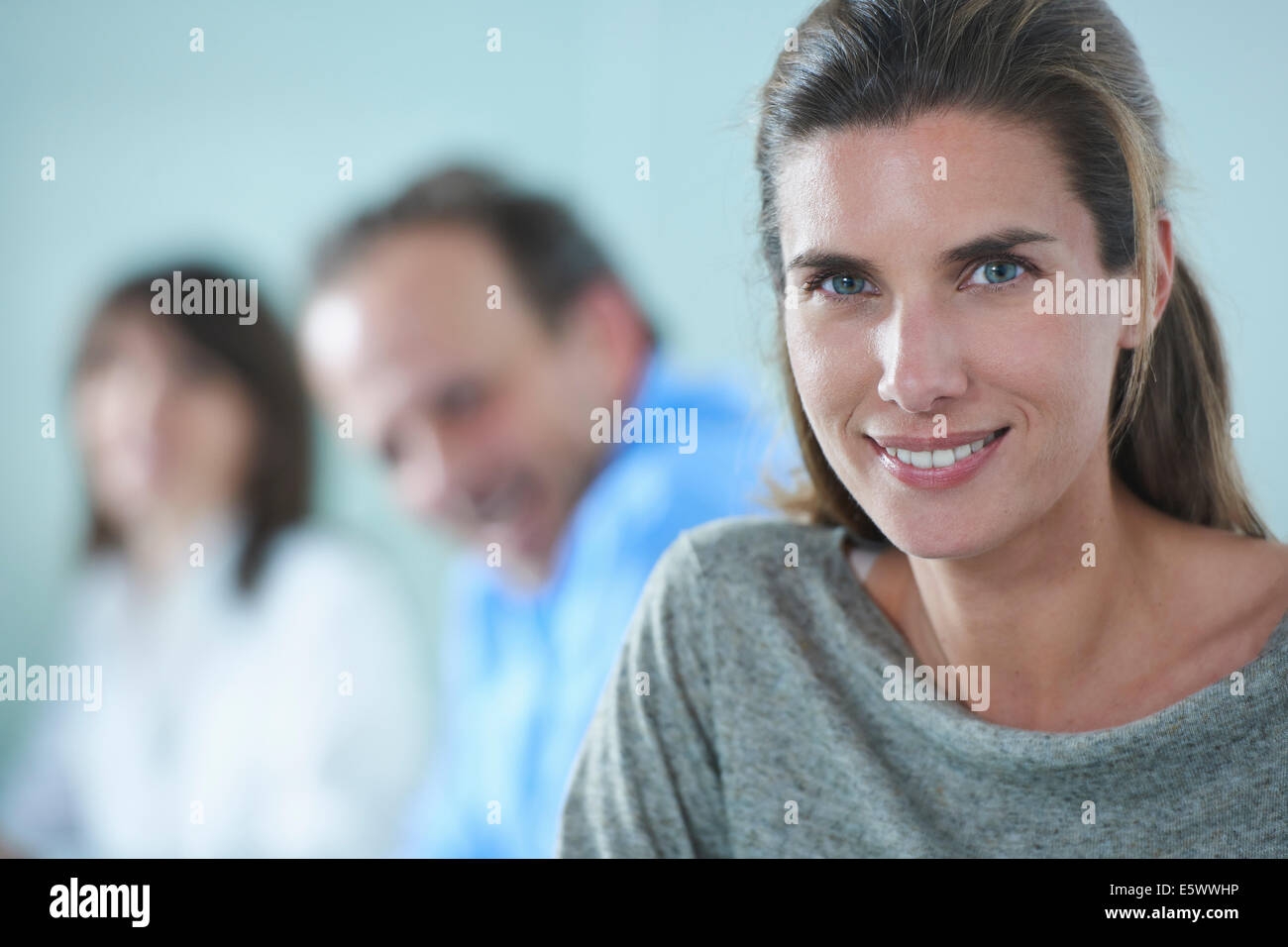 Portrait of businesswoman in row of colleagues Stock Photo
