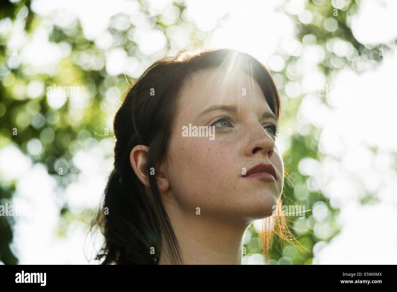 Close up portrait of serene young woman in park Stock Photo - Alamy