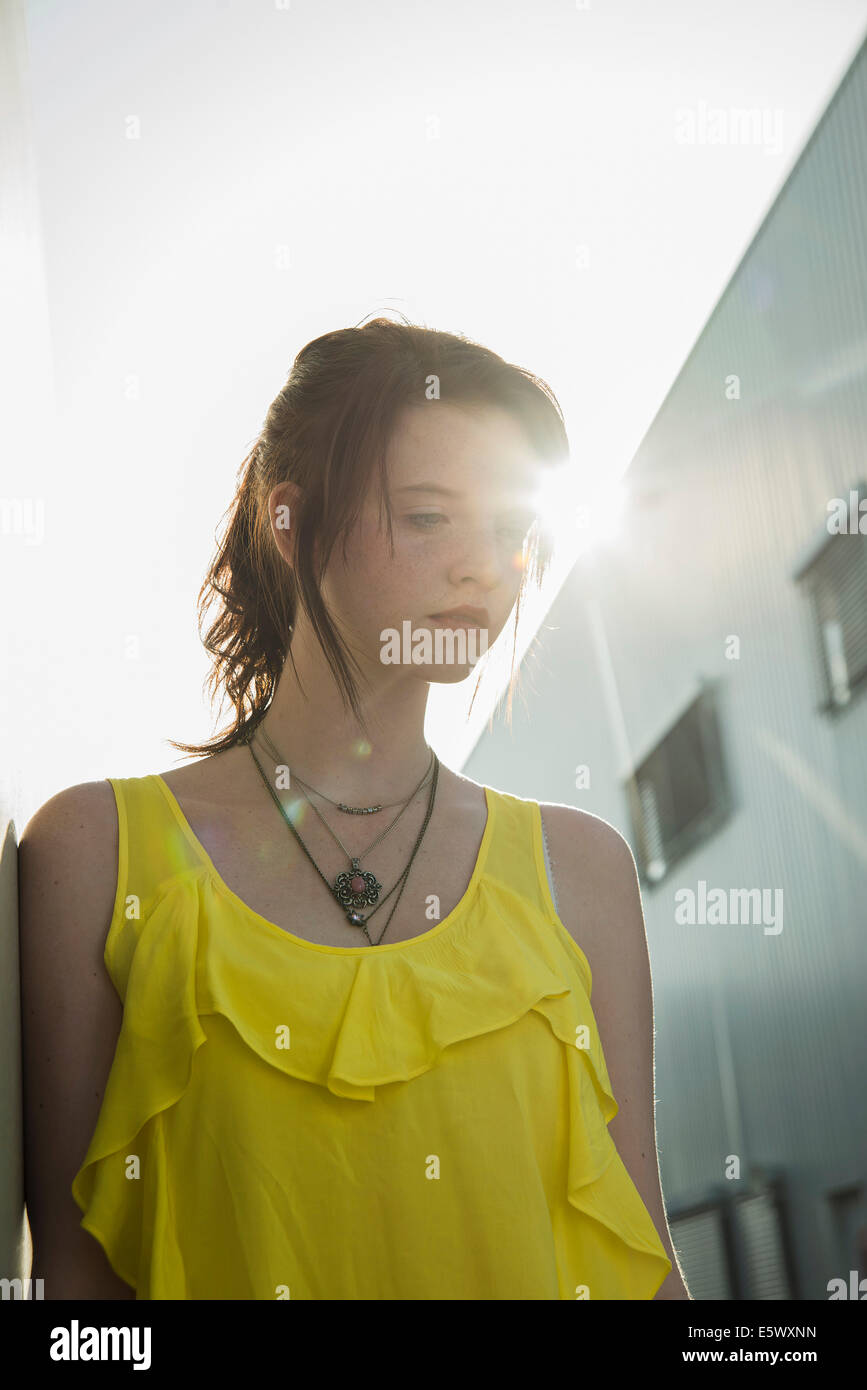 Young sullen girl in yellow blouse gazing down Stock Photo - Alamy