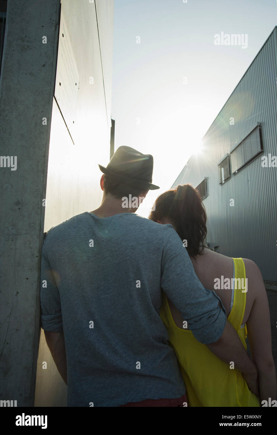 Rear view of young couple in street Stock Photo