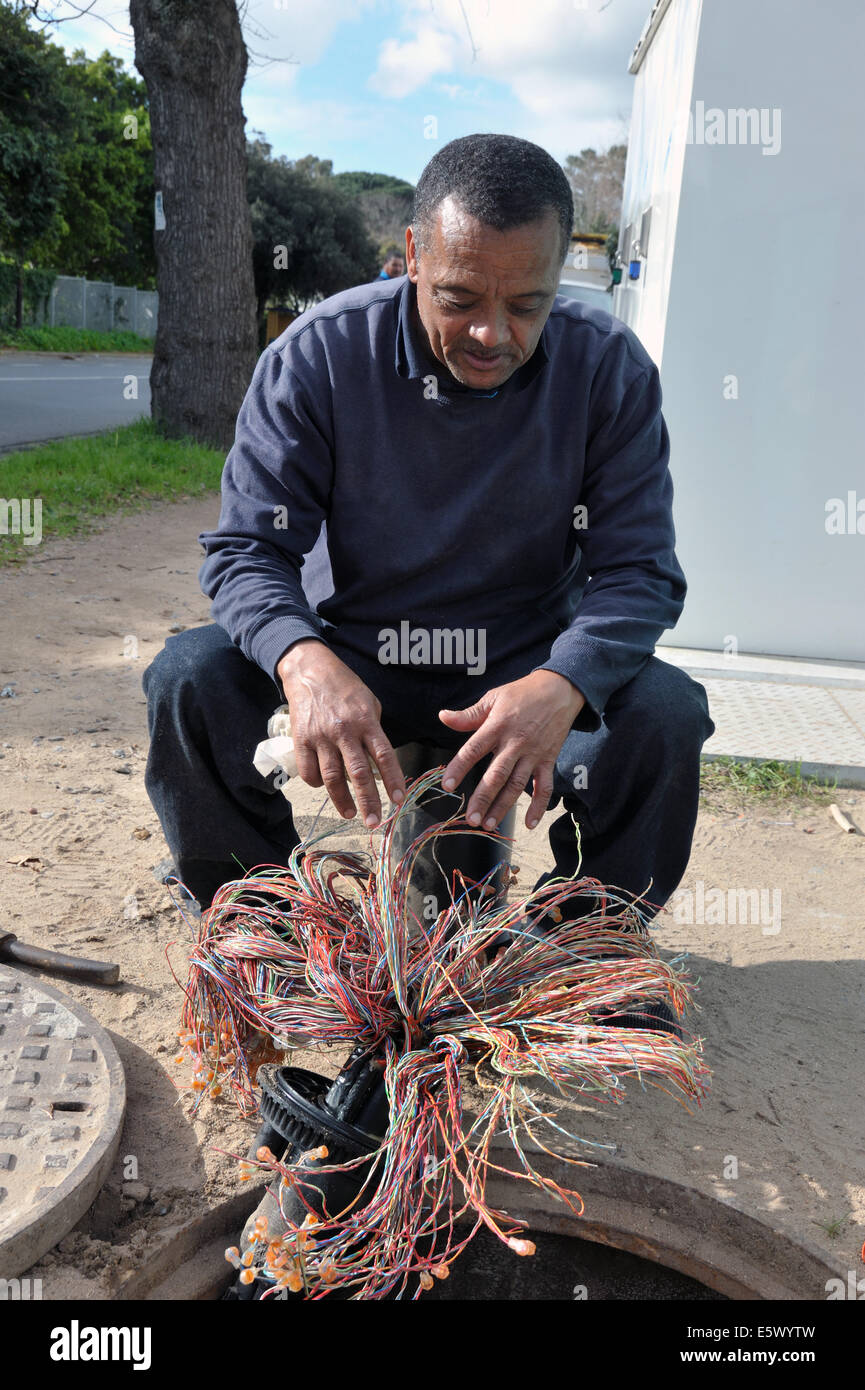 Telkoms worker upgrading residential phone wiring Stock Photo