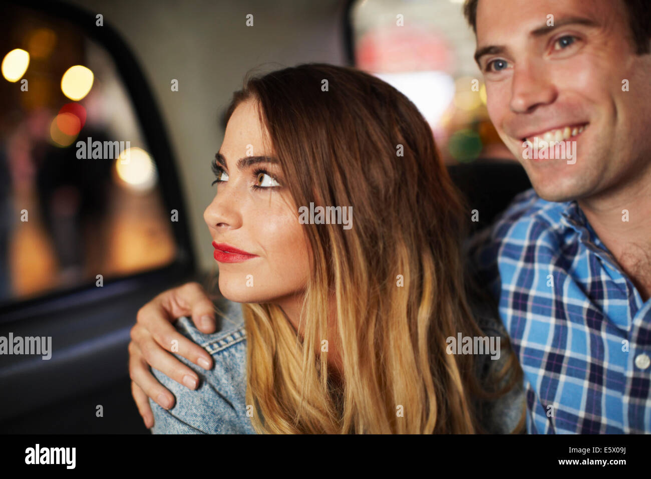 Couple going out in city taxi at night Stock Photo