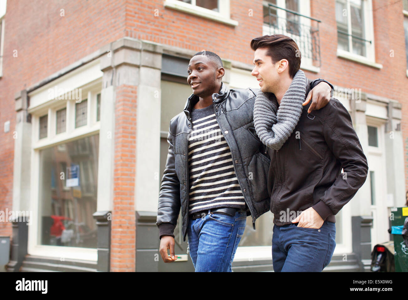 Men with arms around each other hi-res stock photography and images - Alamy