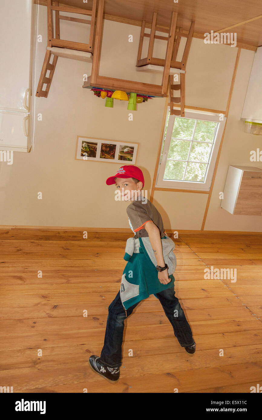 Boy inside upside-down house in Jastrzębia Góra, Poland Stock Photo - Alamy