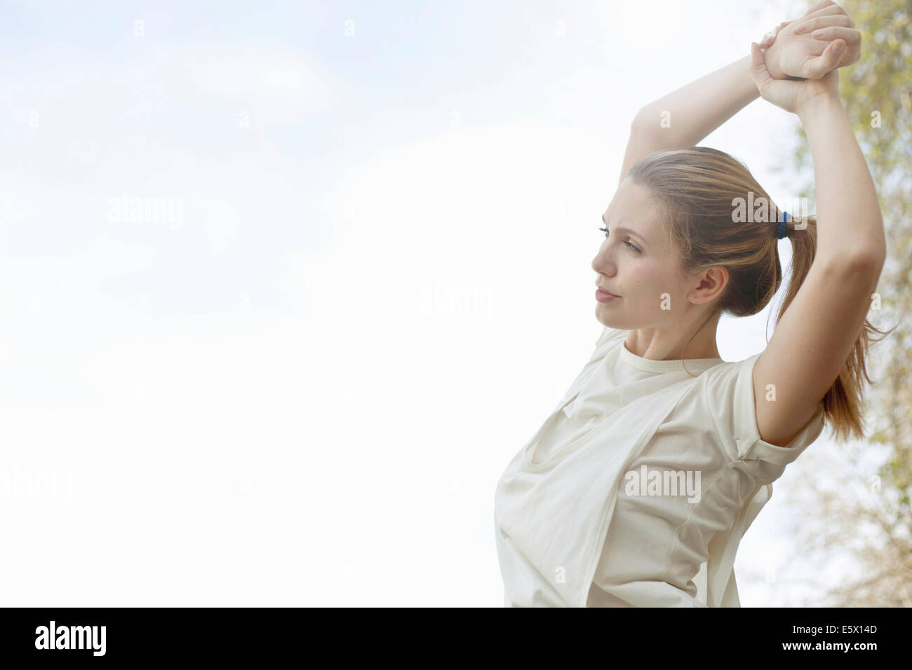 Young woman stretching arms before exercise Stock Photo Alamy