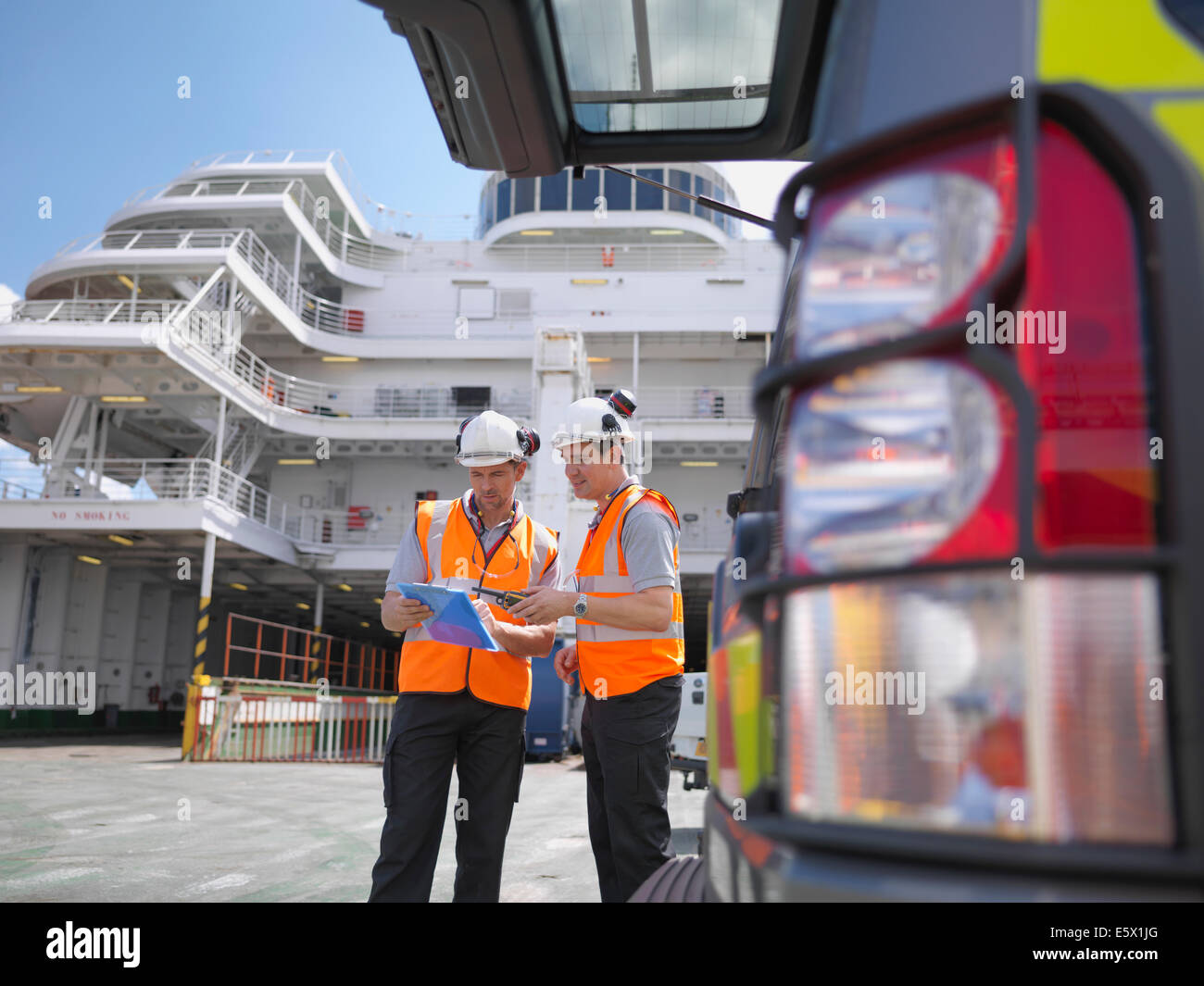 Loading workers on deck of ferry Stock Photo