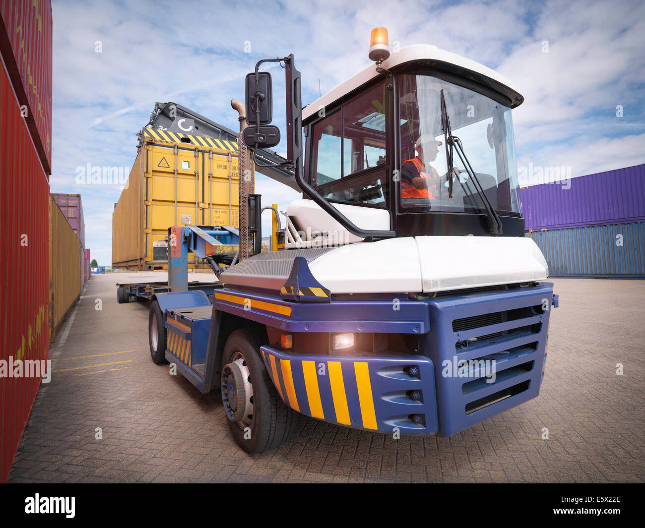 Crane unloading shipping containers from truck in port Stock Photo Alamy
