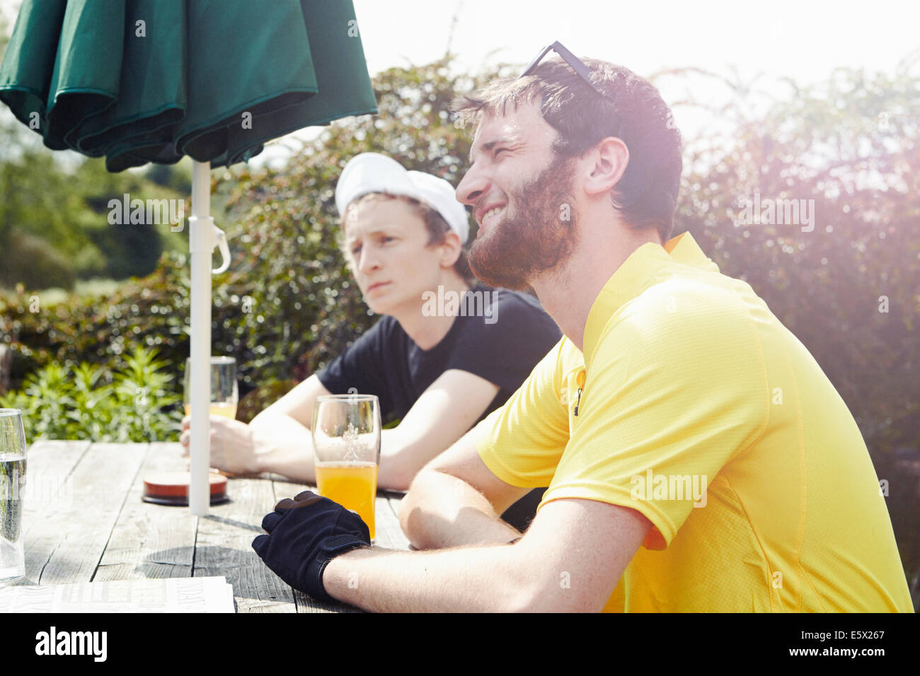 Cyclists in beer garden in pub Stock Photo