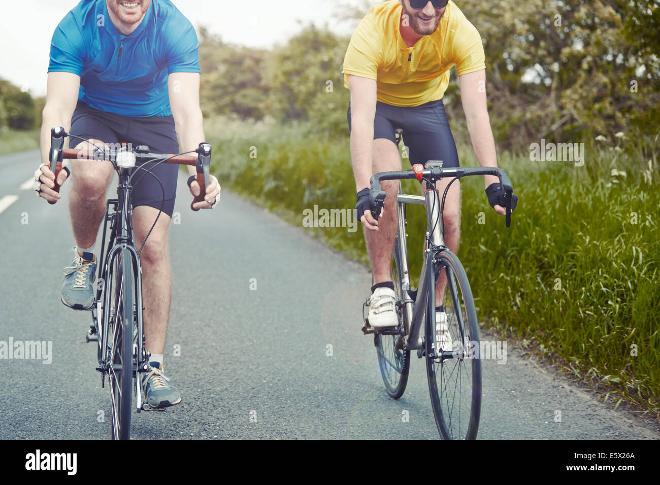 Cyclists riding on single carriageway, Cotswolds, UK Stock Photo