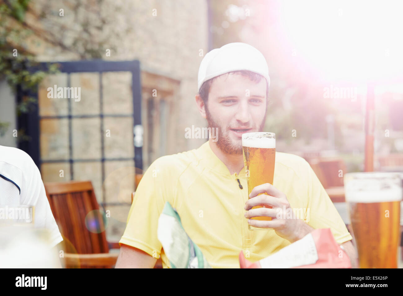 Cyclist in beer garden in pub Stock Photo