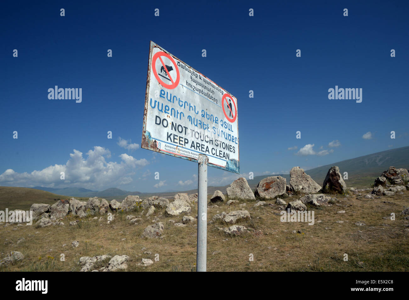Sisian, Armenia. 27th June, 2014. A sign in Armenian and English at the prehistoric archaeological site Zorats Karer asks visitors no to touch the stones and to keep the site clean near Sisian, Armenia, 27 June 2014. The site served as a necropolis from the Middle Bronze Age to the Iron Age. Photo: Jens Kalaene -NO WIRE SERVICE-/dpa/Alamy Live News Stock Photo
