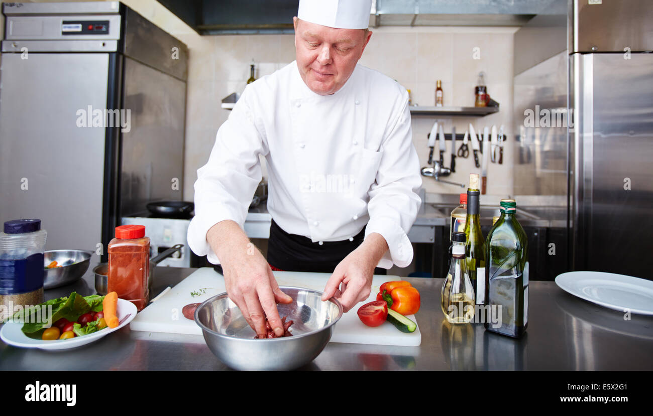 Image of male chef cooking meat in the kitchen Stock Photo - Alamy