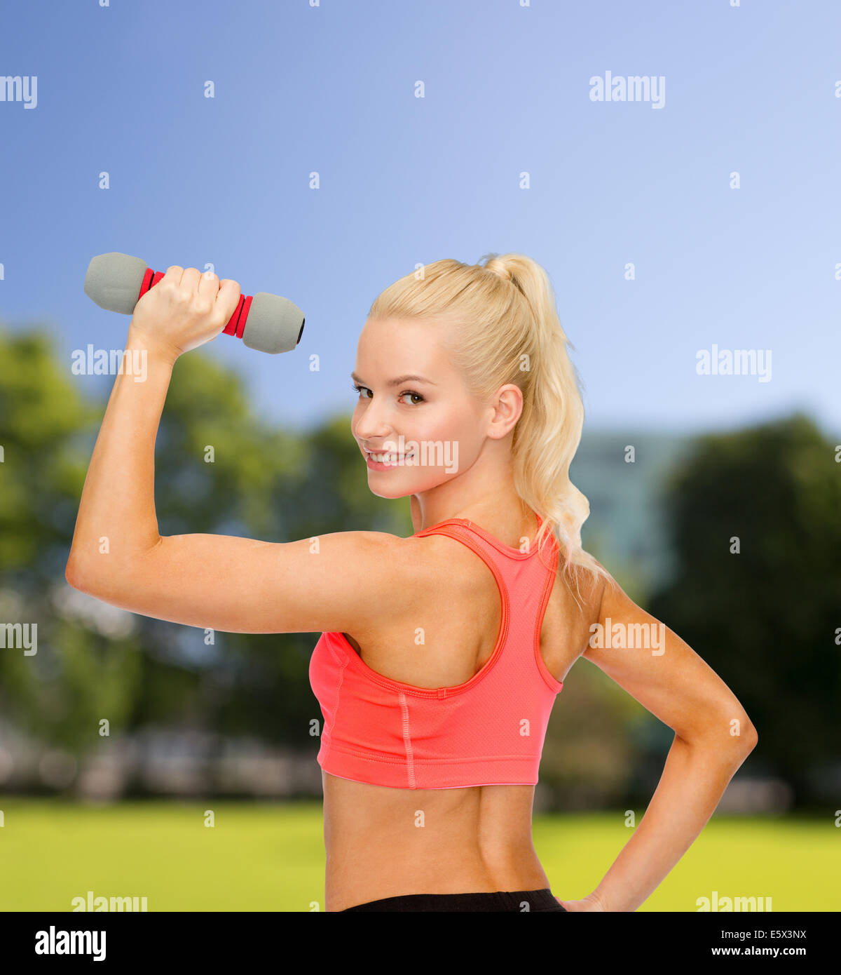 young sporty woman with light dumbbell Stock Photo