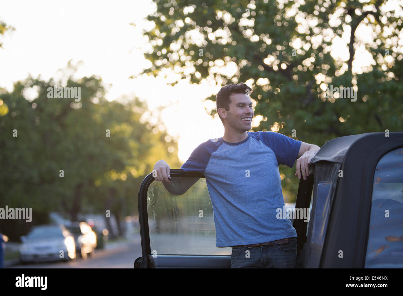 Man leaning against jeep door Stock Photo