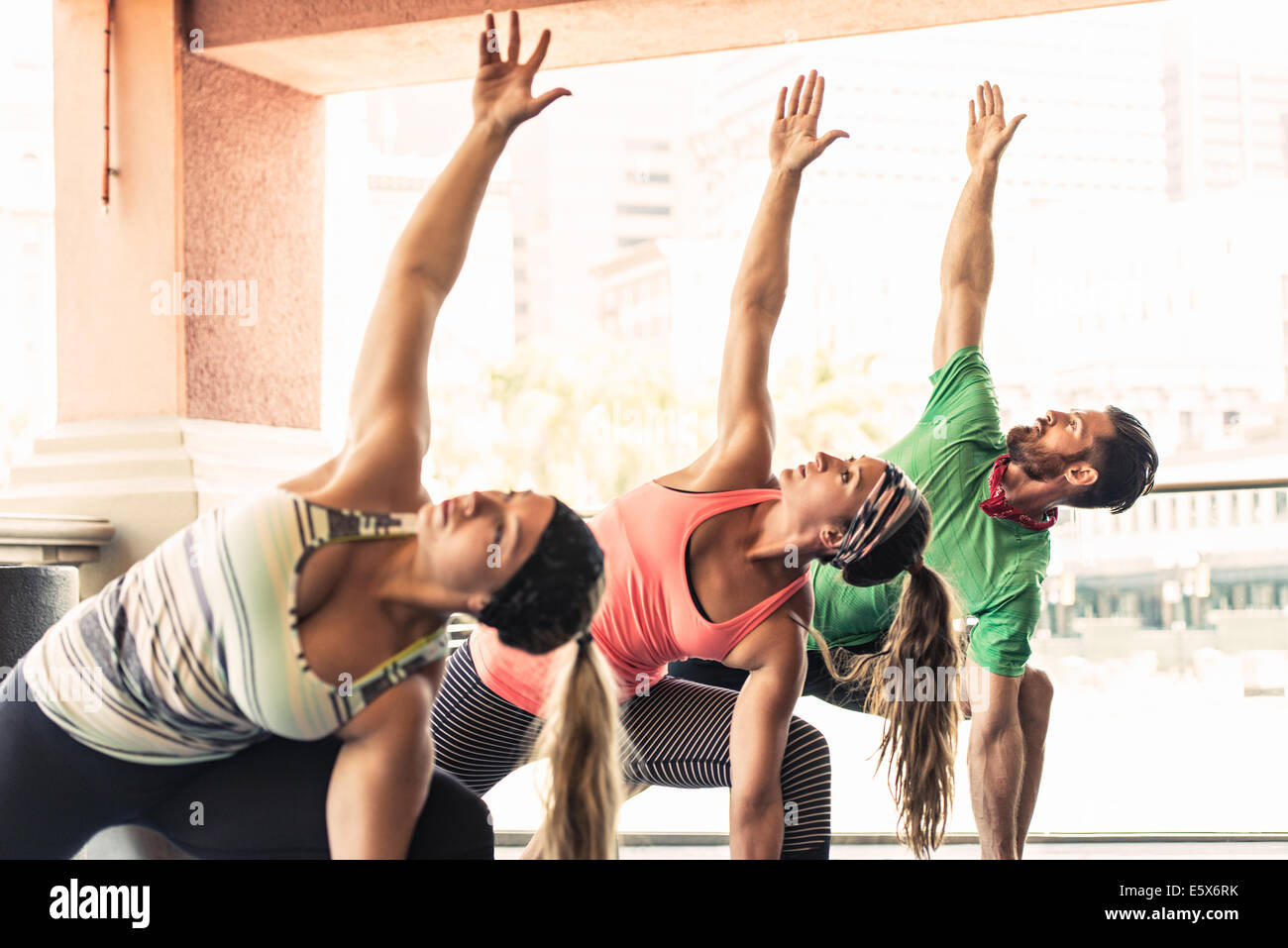 Group of young adults doing yoga Stock Photo