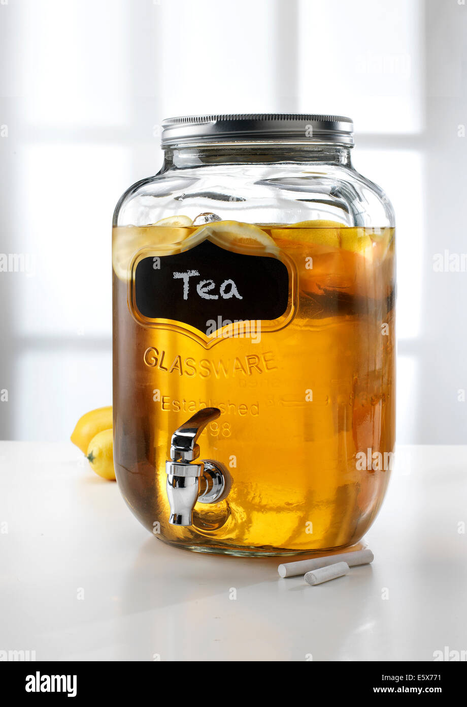 https://c8.alamy.com/comp/E5X771/glass-jar-with-tap-dispenser-containing-fresh-lemon-tea-drink-E5X771.jpg