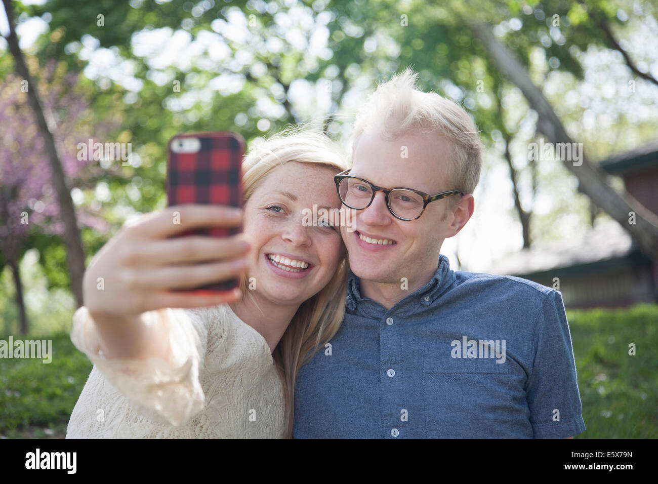 Young couple in park taking selfie with smartphone Stock Photo - Alamy