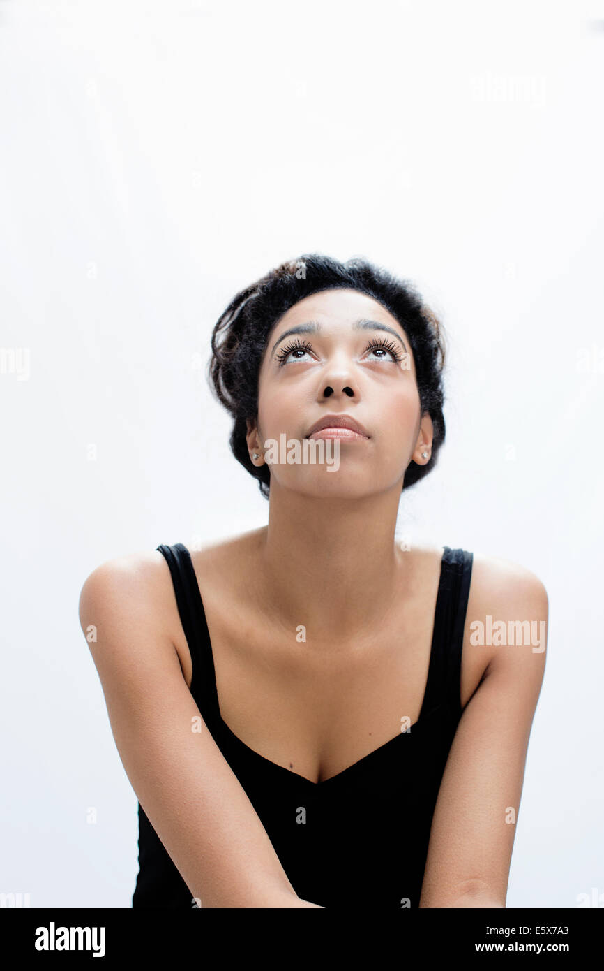 Studio portrait of serene young woman gazing upward Stock Photo