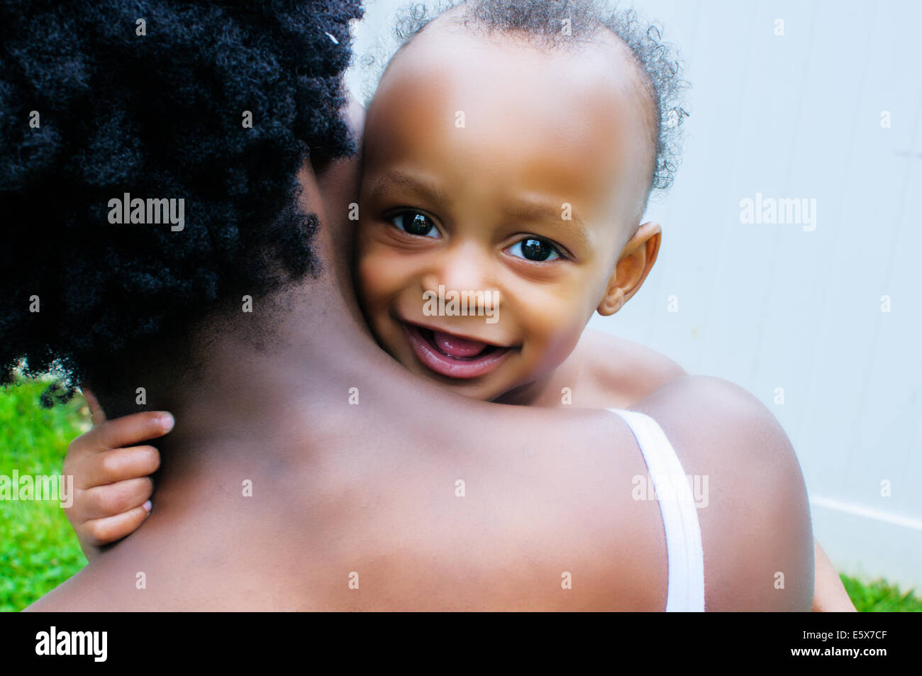 Close up portrait of baby boy looking over mother's shoulder Stock Photo
