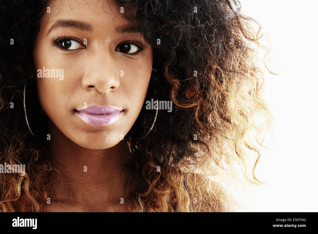 Close up studio portrait of young woman glancing sideways Stock Photo