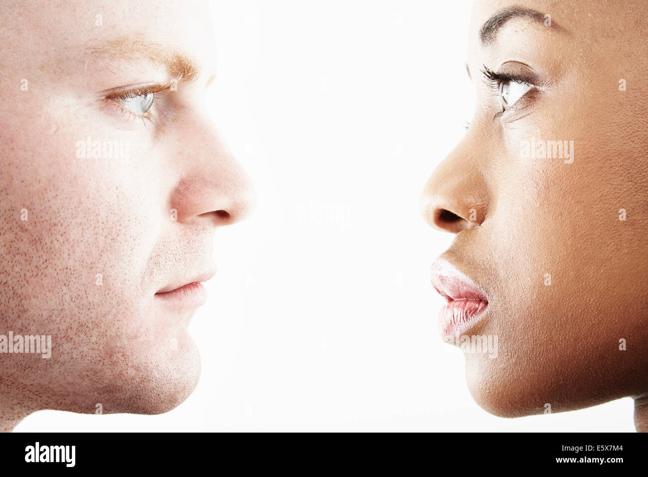Cropped studio portrait of young couple face to face in profile Stock Photo