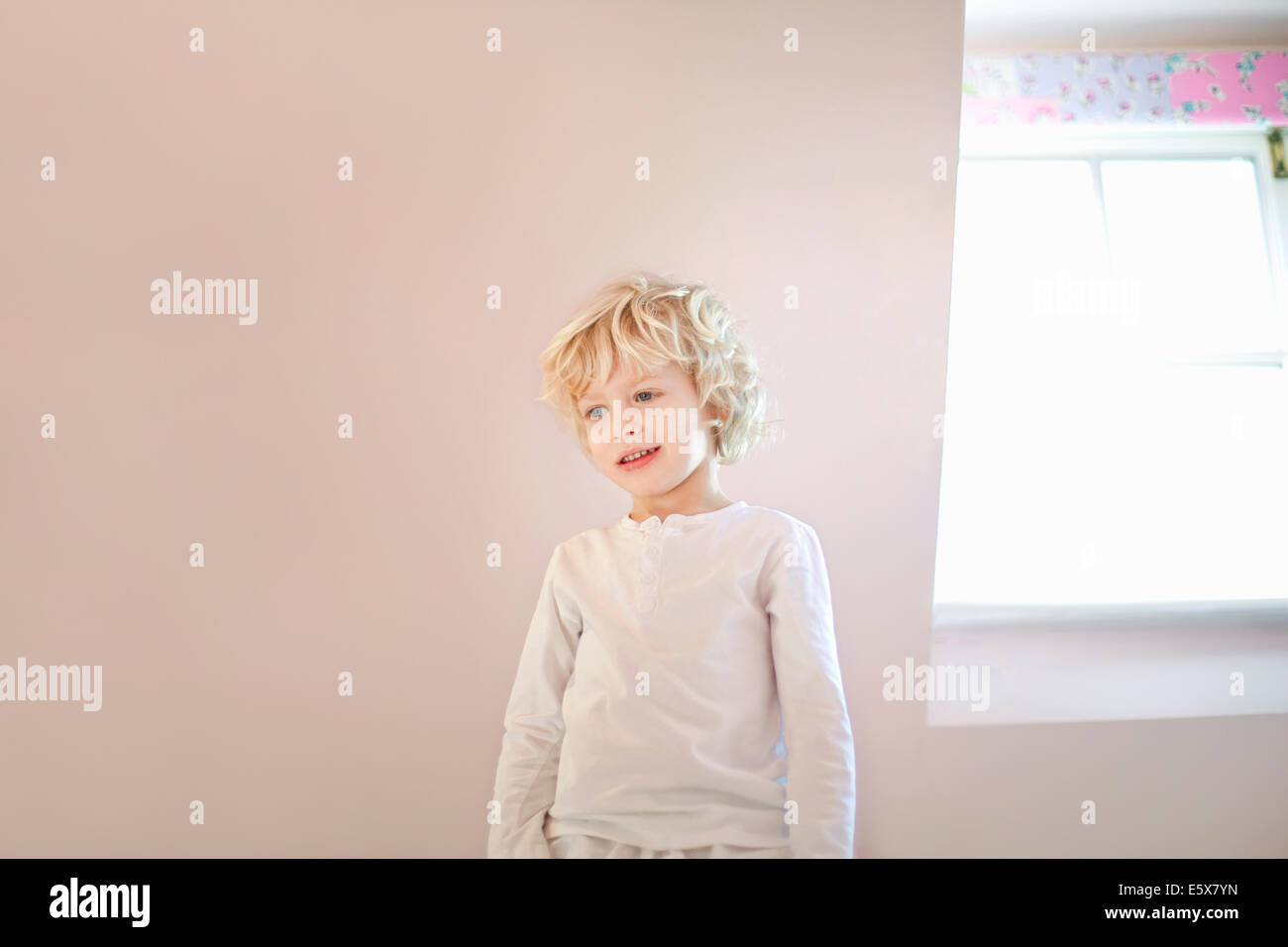 Portrait of four year old boy in bedroom Stock Photo