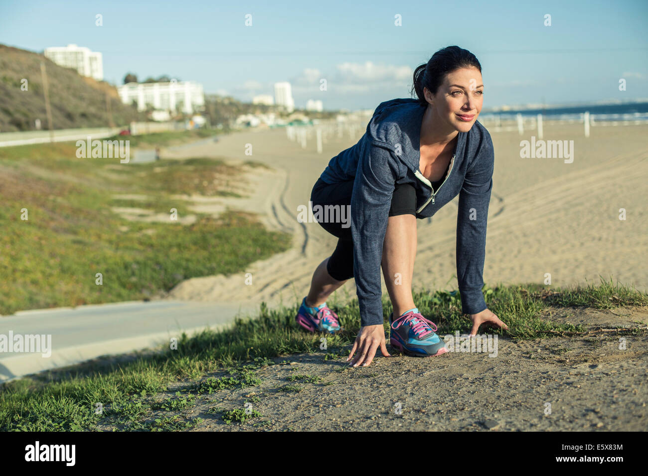 Jogger on her mark by beach Stock Photo