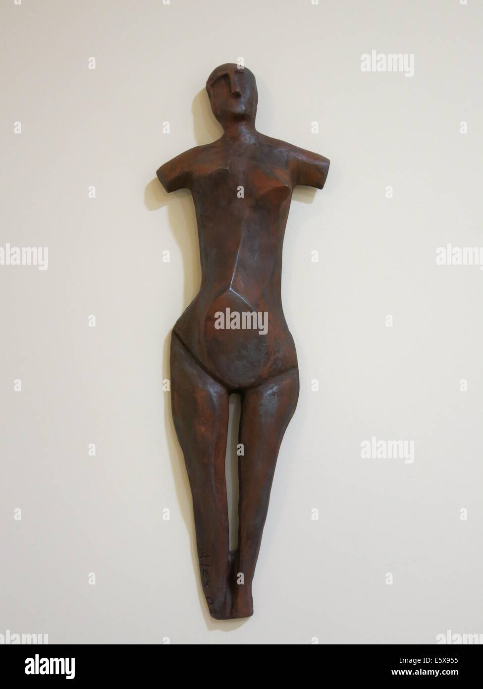Image of pregnant female statuette hanging on the wall. Stock Photo