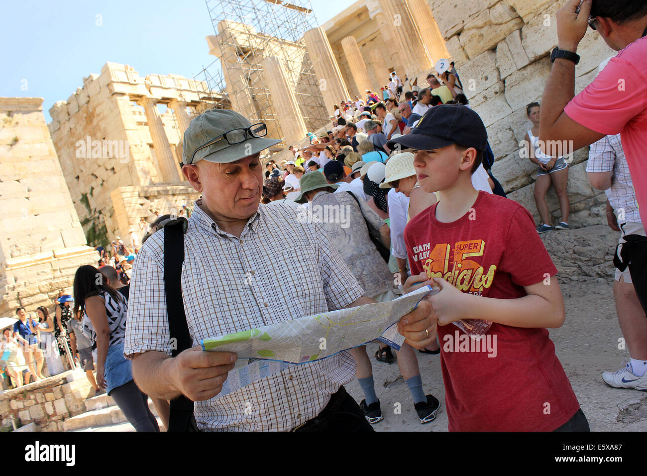 Father and son looking at tourist map whilst visiting Acropolis Parthenon, Athens, Greece. Stock Photo