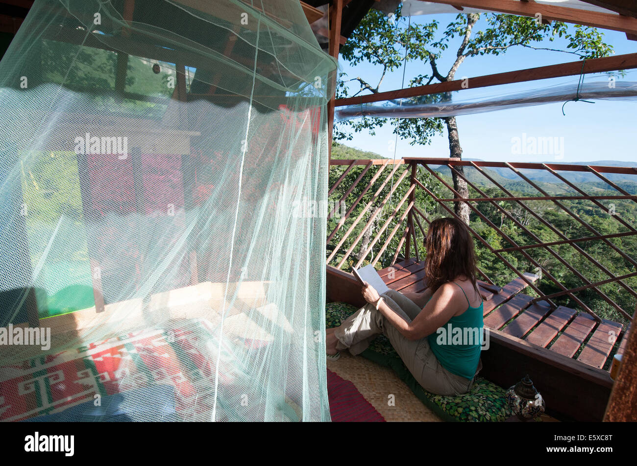 Woman reading in treehouse Goiás state Brazil Stock Photo