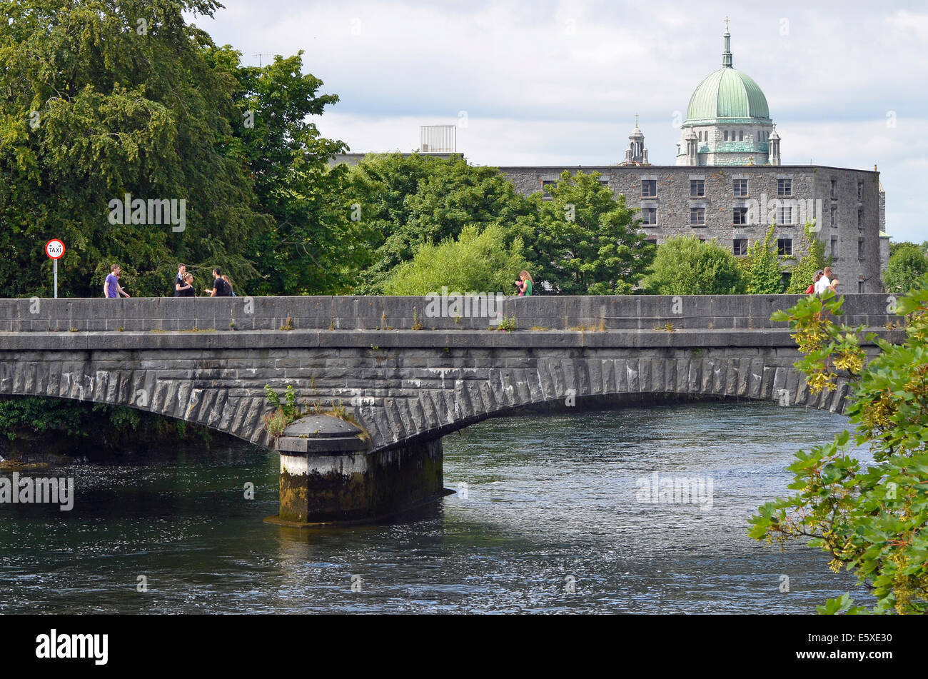 Wolfe Tone Bridge, the most southerly bridge over the River Corrib in Galway city, Ireland with dome of cathedral visible. Stock Photo