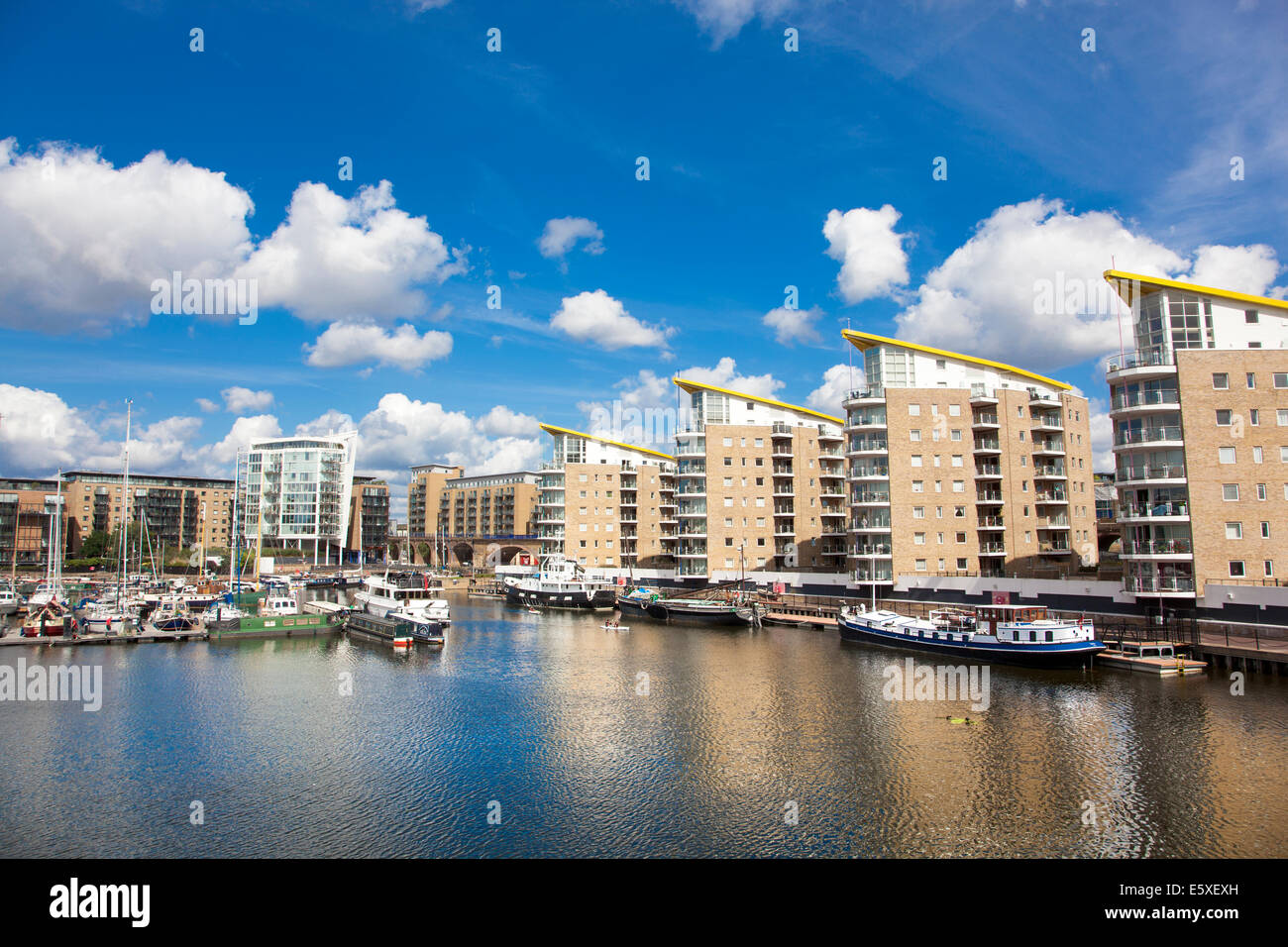 Boats mooring in the Limehouse Basin surrounded by residential blocks, Berglen Court, Pinnacle I and Marina Heights, Tower Hamlets, London, UK Stock Photo