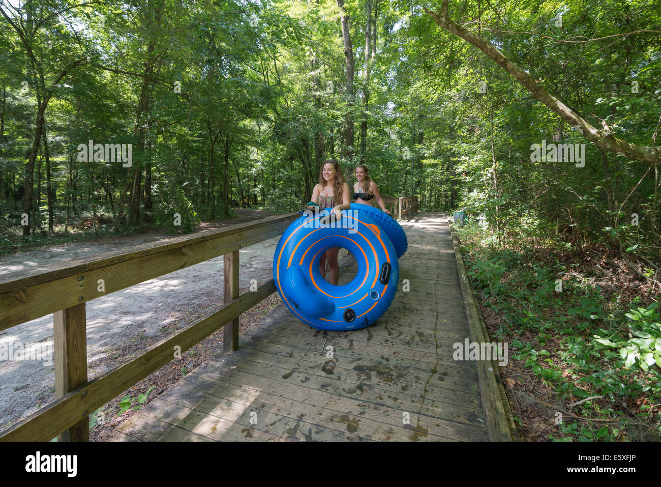 People walking down to one of the starting points for tubing down the Ichetucknee River in North Florida. Stock Photo